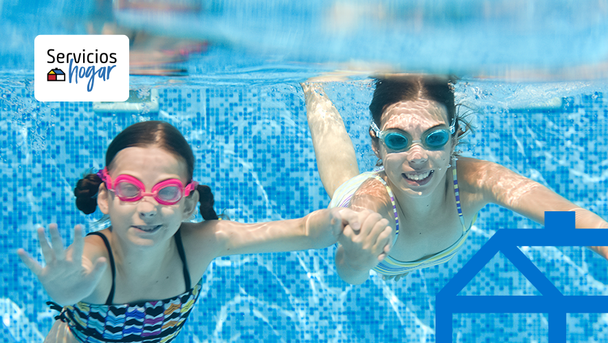 Dos niñas bajo el agua con lentes de natación disfrutando del temperado de piscina